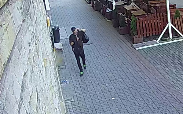 zdjęcie kolorowe: mężczyzna ubrany na czarno podejrzewany o kradzież plecaka