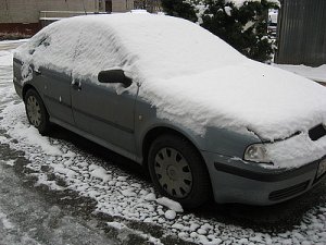 zdjęcie kolorowe: zaśnieżony szary samochód osobowy