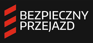 zdjęcie kolorowe: na czarnym tle trzy czerwone pasy i napis o treści "Bezpieczny przejazd