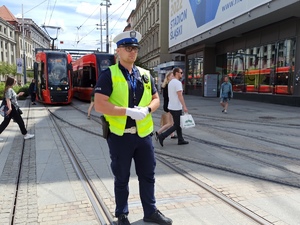 zdjęcie kolorowe:  policjant katowickiej drogówki wstrzymujący ruch tramwajów w centrum Katowic
