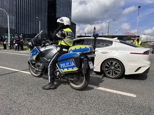 zdjęcie kolorowe: policjanci wydziału ruchu drogowego podczas zabezpieczenia marszu