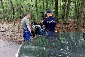 Na zdjęciu policjant i strażnik w trakcie kontroli motocyklisty